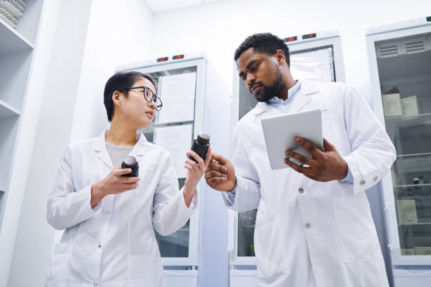 istock Pharmacists keeping records in medical storage room 1149117455