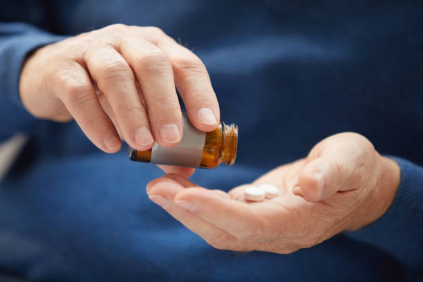 istock Senior Man Taking Pills Closeup 1149118298
