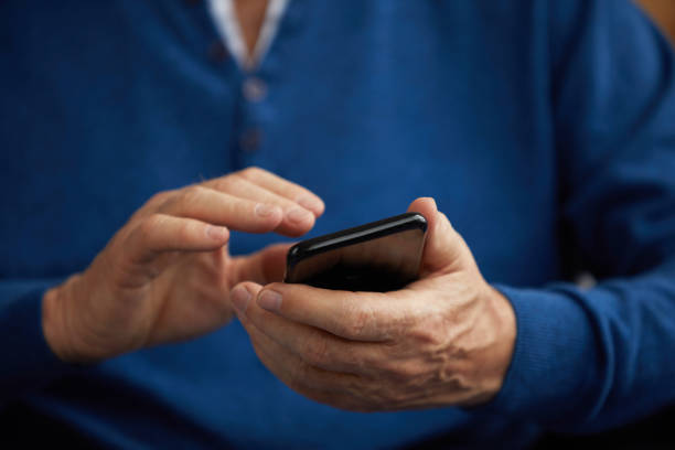 istock Senior Man Holding Smartphone 1149118898