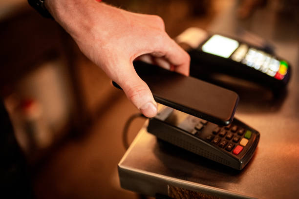 istock Contactless payment using a smart phone hand close up. 1149120757