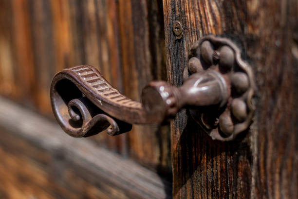 istock Old metal - iron, handle on a wooden door. 1149121098
