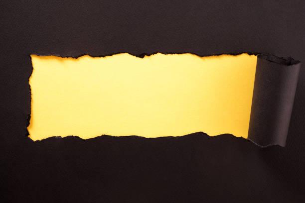istock Paper strip torn black yellow background horizontal 1149127507