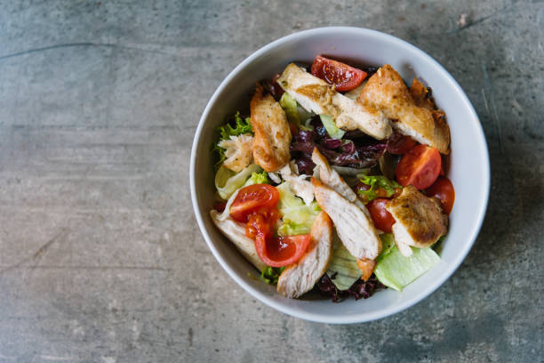 istock Grilled chicken meat and fresh vegetable salad 1149128453