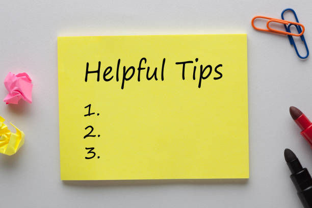 Helpful Tips List Helpful Tips text on note with marker pen and various stationery. Business concept tips tricks stock pictures, royalty-free photos & images