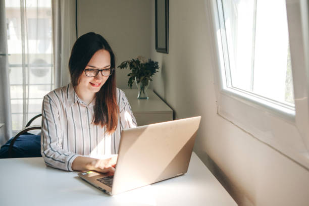 Girl working using laptop in home office