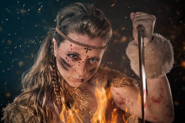 istock Beautiful young Amazon female warrior posing in a fighting stance with a dagger. 1149130935