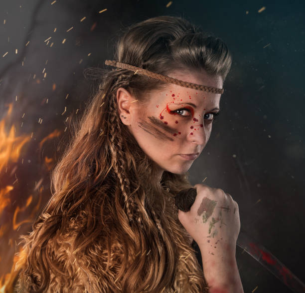 istock Beautiful young Amazon female warrior posing in a fighting stance with a dagger. 1149130957