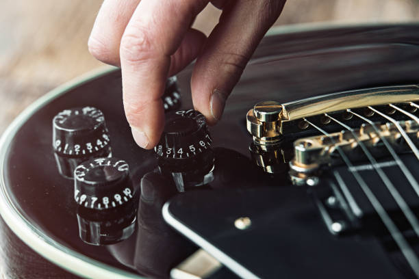 istock Male hand changing electric guitar settings. Tuning a timbre regulator 1149131112