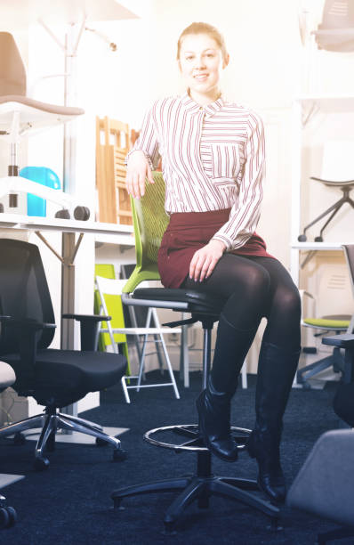 istock Young woman testing new chairs in salon 1149131583