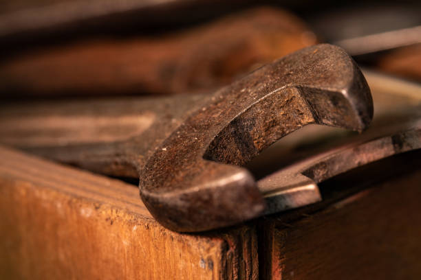 Old rusty spanners in a wooden box. Old rusty tools closeup. Old tools in the workshop.