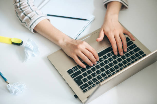 istock Top view on female hands behind the laptop 1149132712