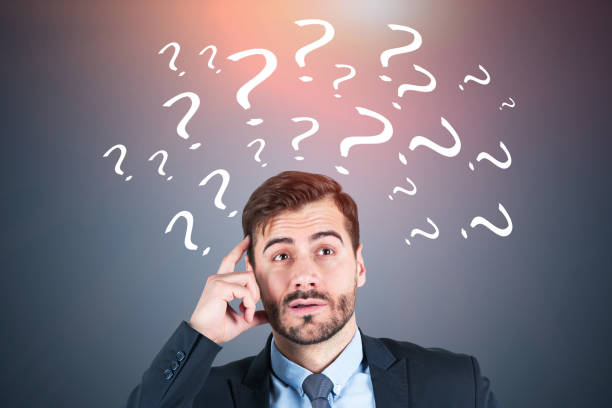 istock Confused businessman, gray question marks 1149137541