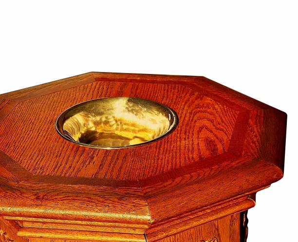 istock Sun shining on antique wood baptism font 1149138059