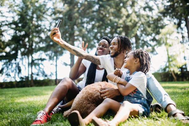 istock Family Taking Selfie In Park With Dog 1149138306