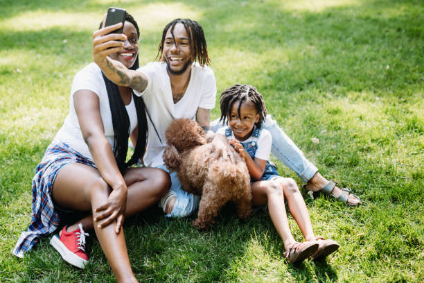 istock Family Taking Selfie In Park With Dog 1149139015