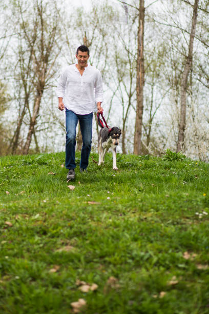 istock Japanese man running with dog in nature 1149140589
