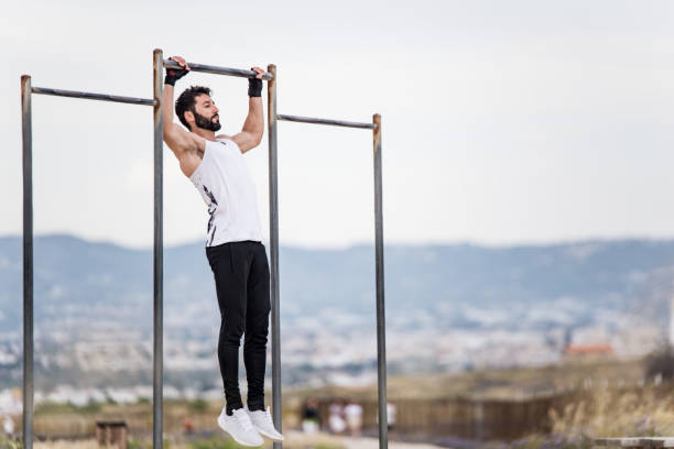 istock Young male athlete doing pull ups outdoors. 1149143898