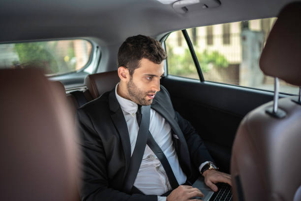 istock Dedicated businessman working in a cab on the way to office 1149154479