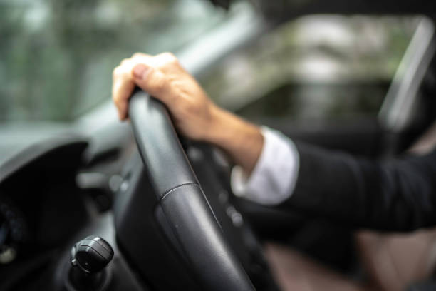 istock Cropped hands of man driving car 1149155288