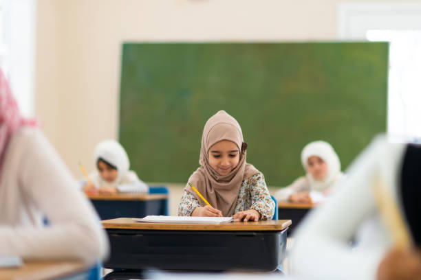 istock Smiling muslim girl writing 1149156659