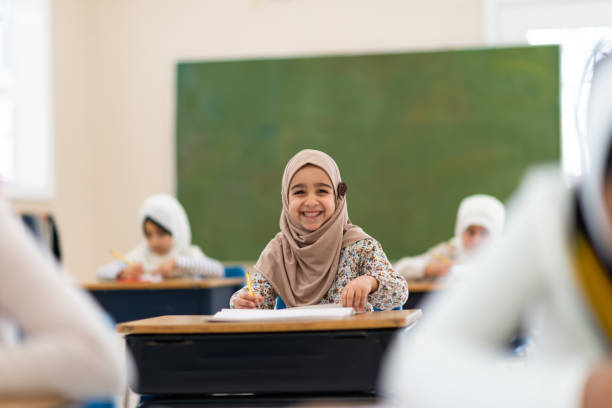 istock Smiling muslim girl writing 1149156663