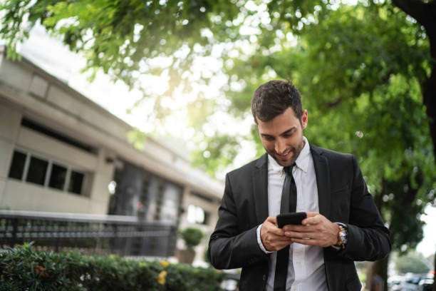 istock Businessman using cellphone in the street 1149156748