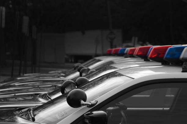 Copland A fleet of black and white police cars with the red, white, and blue lights atop. police car photos stock pictures, royalty-free photos & images