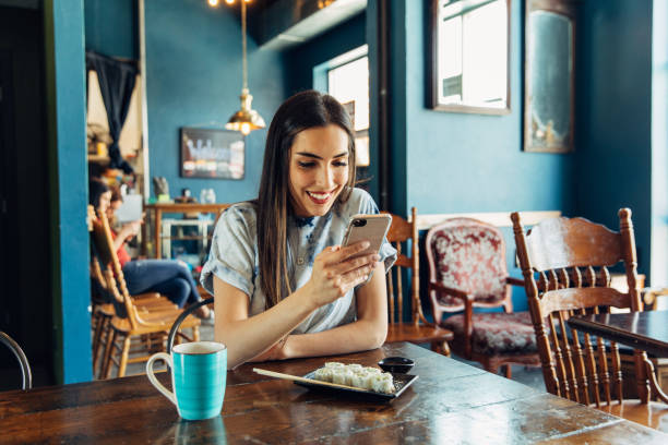 istock Hispanic Woman Checking Finances at Restaurant 1149169909