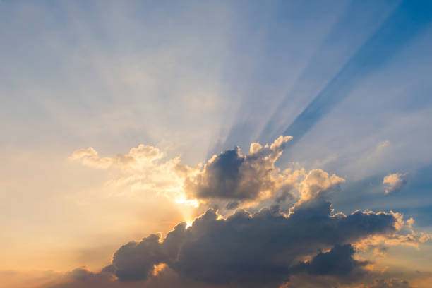 istock Beautiful dramatic sky clouds with light rays at sunset. Natural landscape for background 1149170766
