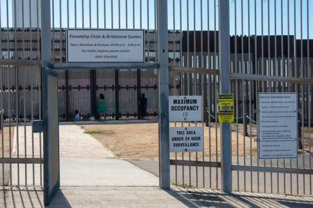 Separated migrant family members reunite with relatives through border wall on United States - Mexico international border San Diego, California, USA - November 3, 2018 : Separated migrant family members reunite with relatives through border wall on United States - Mexico international border at Friendship Park exclusion group of people separation fish out of water stock pictures, royalty-free photos & images