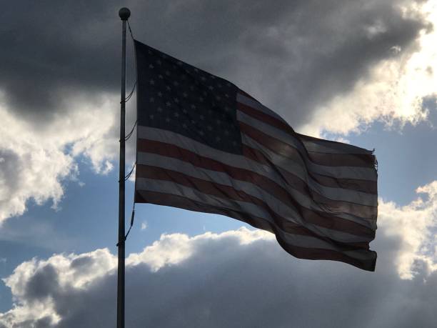 istock Dark clouds and Stars and Stripes. 1149178003