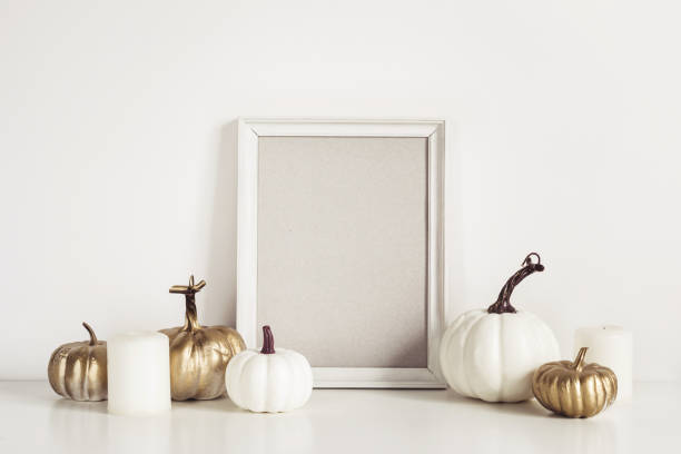 istock Mockup composition with photo frame, white pumpkins and candles. Copy space for artwork 1149178280
