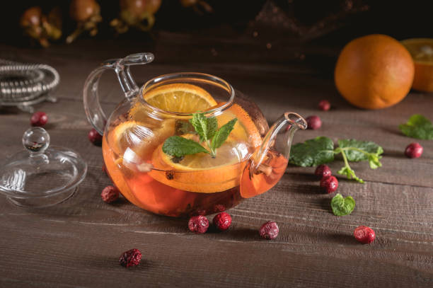 istock Glass teapot with herbal tea, orange and mint 1149182747