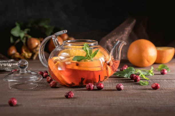 istock Glass teapot with herbal tea, orange and mint 1149182750