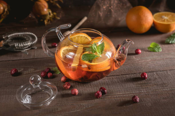 istock Glass teapot with herbal tea, orange and mint 1149182751