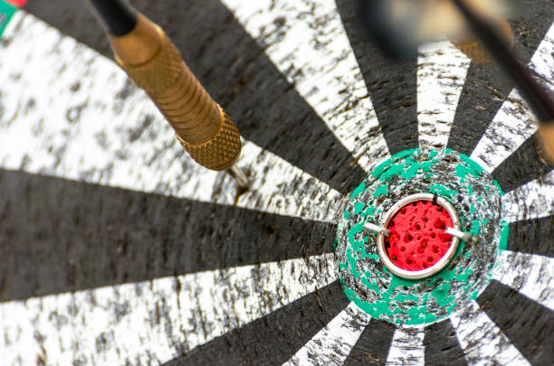 istock Darts Missing Bullseye on a Worn Out Dartboard. Proper Targeting, Losing Concept 1149188143