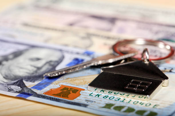 istock House model, the key and the dollar 1149190599