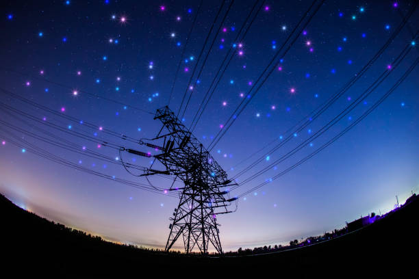istock High voltage towers at night and the Milky Way 1149192529