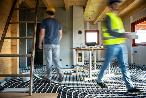 Working at construction site in blurred motion,underfloor heating
