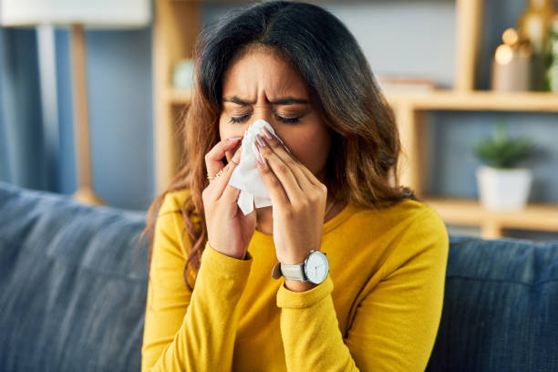 я не смогу пойти куда-нибудь сегодня - sneezing tissue young adult cold стоковые фото и изображения