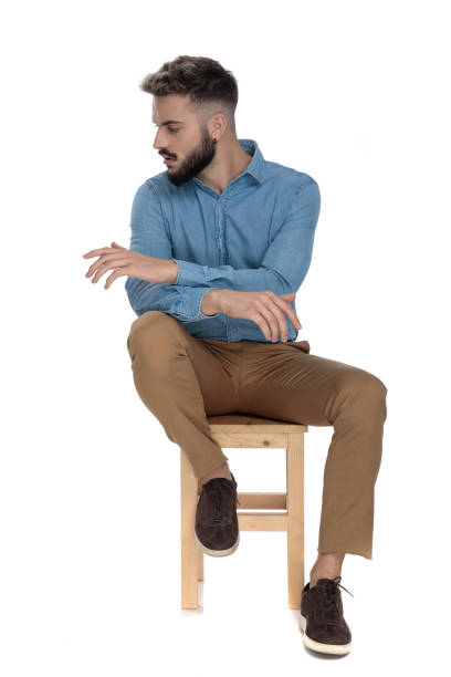 istock seated student looking away with hands crossed 1149202078