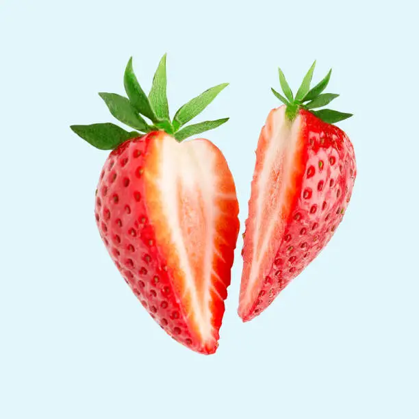 Strawberry. Cut strawberries into pieces. Strawberry slices flying in the air. Fresh natural strawberry isolated .