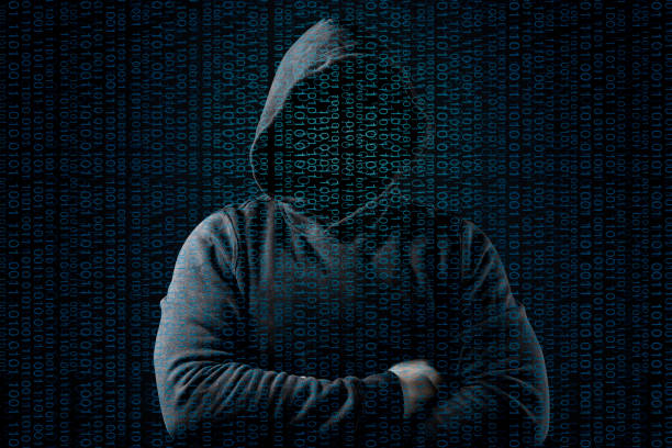 istock Anonymous computer hacker over abstract digital background. Obscured dark face in mask and hood. Data thief, internet attack, 1149203005
