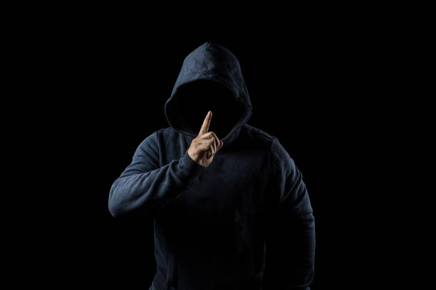 Mysterious, unknown person in the hood. Danger in darkness. anonymous or criminal concept Mysterious, unknown person in the hood. Danger in darkness. anonymous or criminal concept creepy stalker stock pictures, royalty-free photos & images