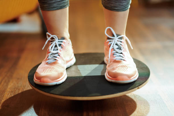 istock Closeup on sports woman while training using balance board 1149203443