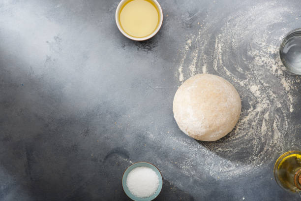 istock Risen or proved yeast dough for bread or pizza on a floured slate surface. Top view 1149203504