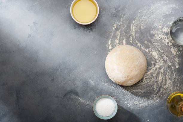 istock Risen or proved yeast dough for bread or pizza on a floured slate surface. Top view 1149203508