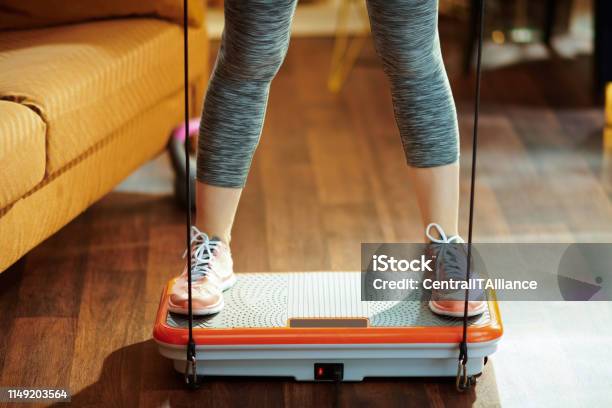 Closeup On Sports Woman Training Using Vibration Power Plate Stock Photo - Download Image Now