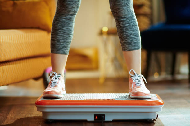 Closeup on young woman training using vibration power plate stock photo