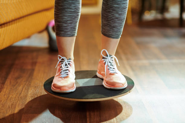 istock Closeup on fit sports woman while training using balance board 1149204360
